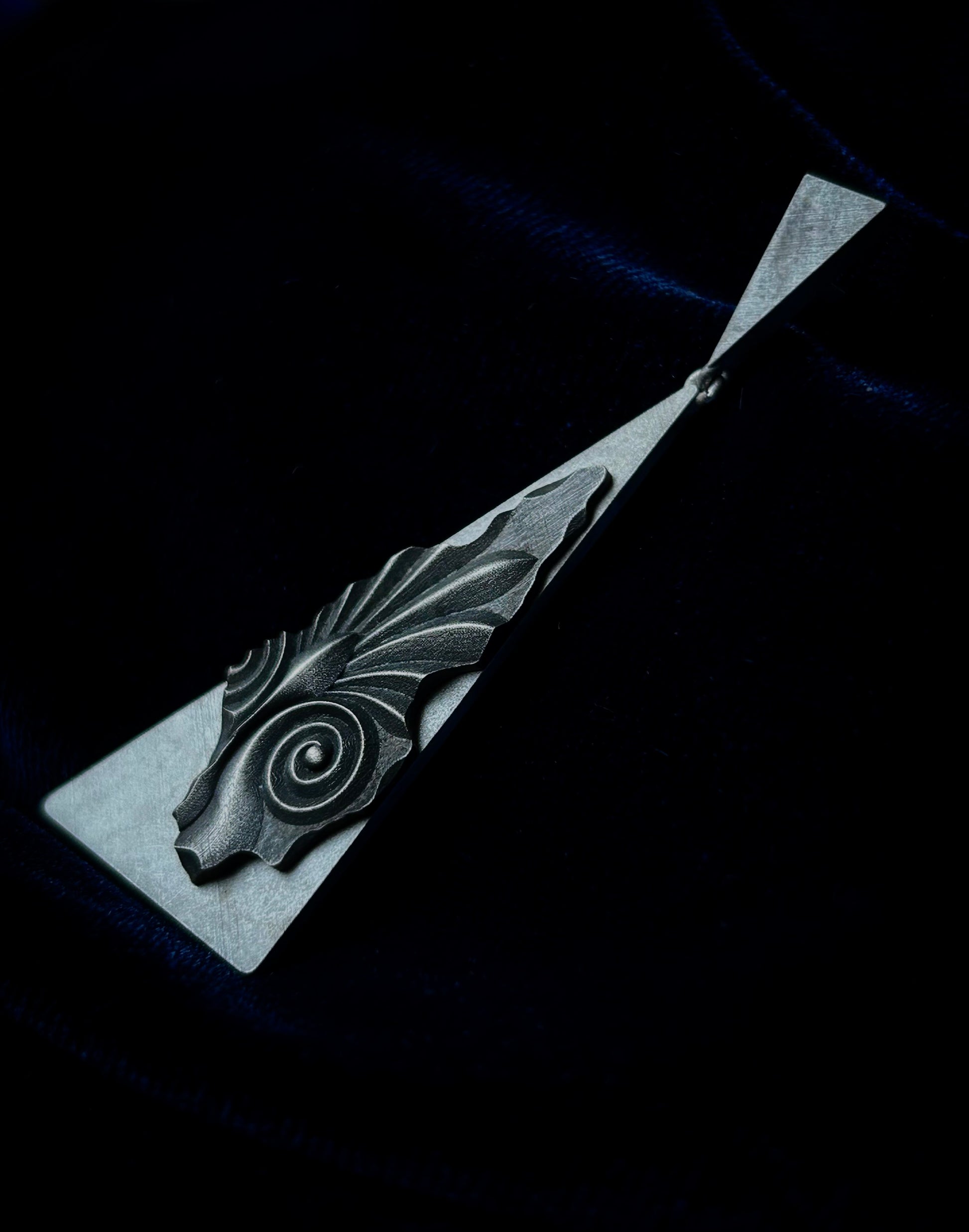 Silver wearable statue on a dark background